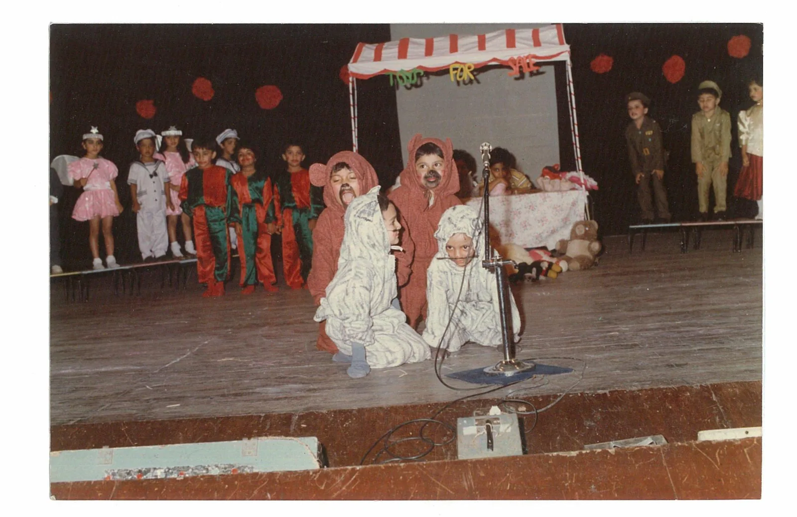 Children in costume on the NAS stage during a school performance