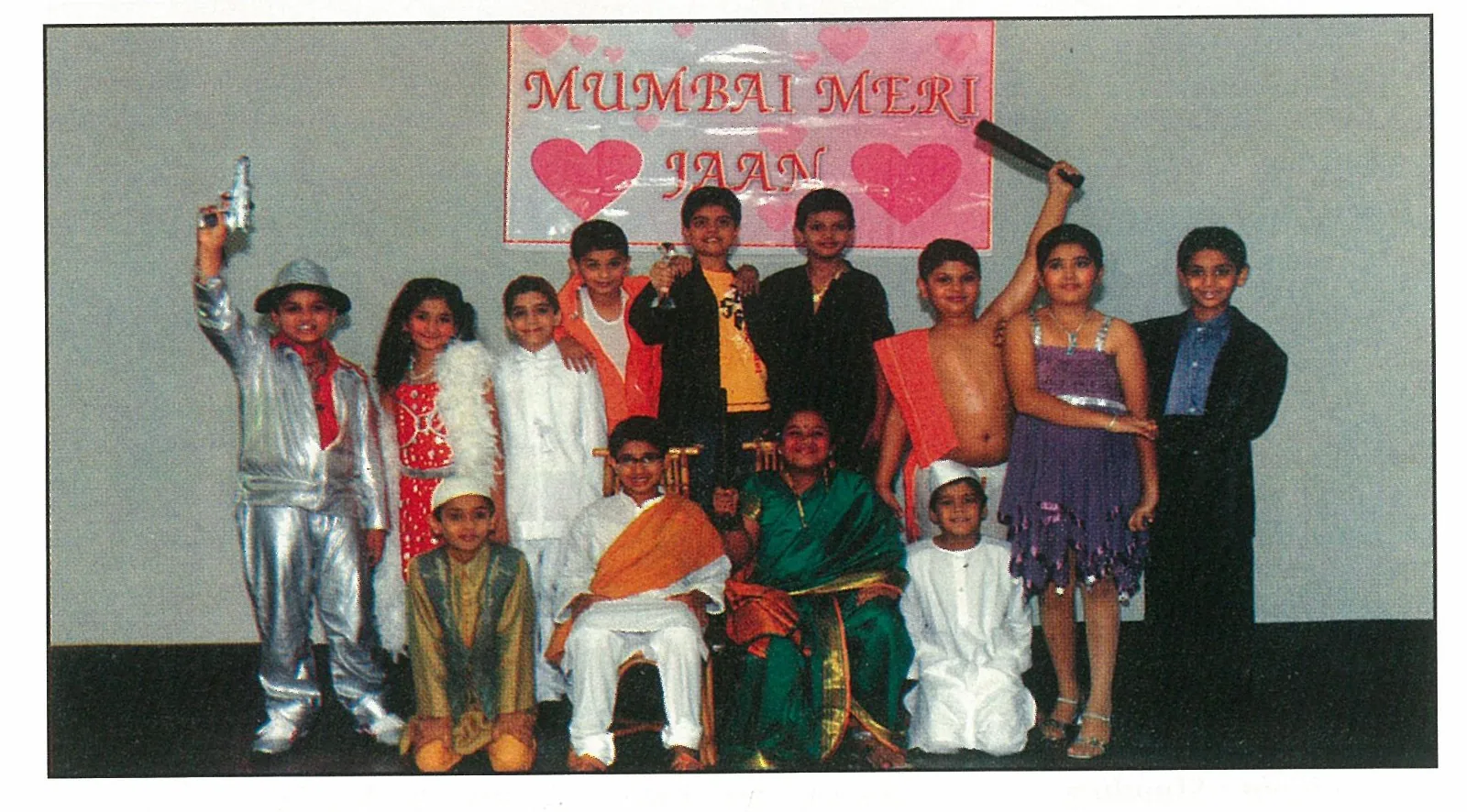 Children in costumes beneath a Mumbai Meri Jaan school backdrop