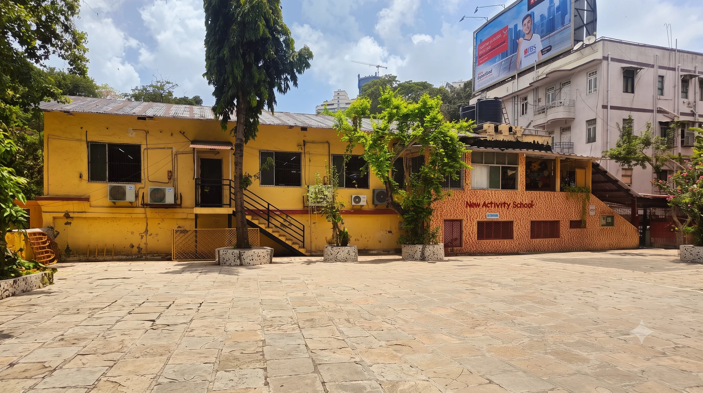 The same New Activity School courtyard today, empty in the morning light