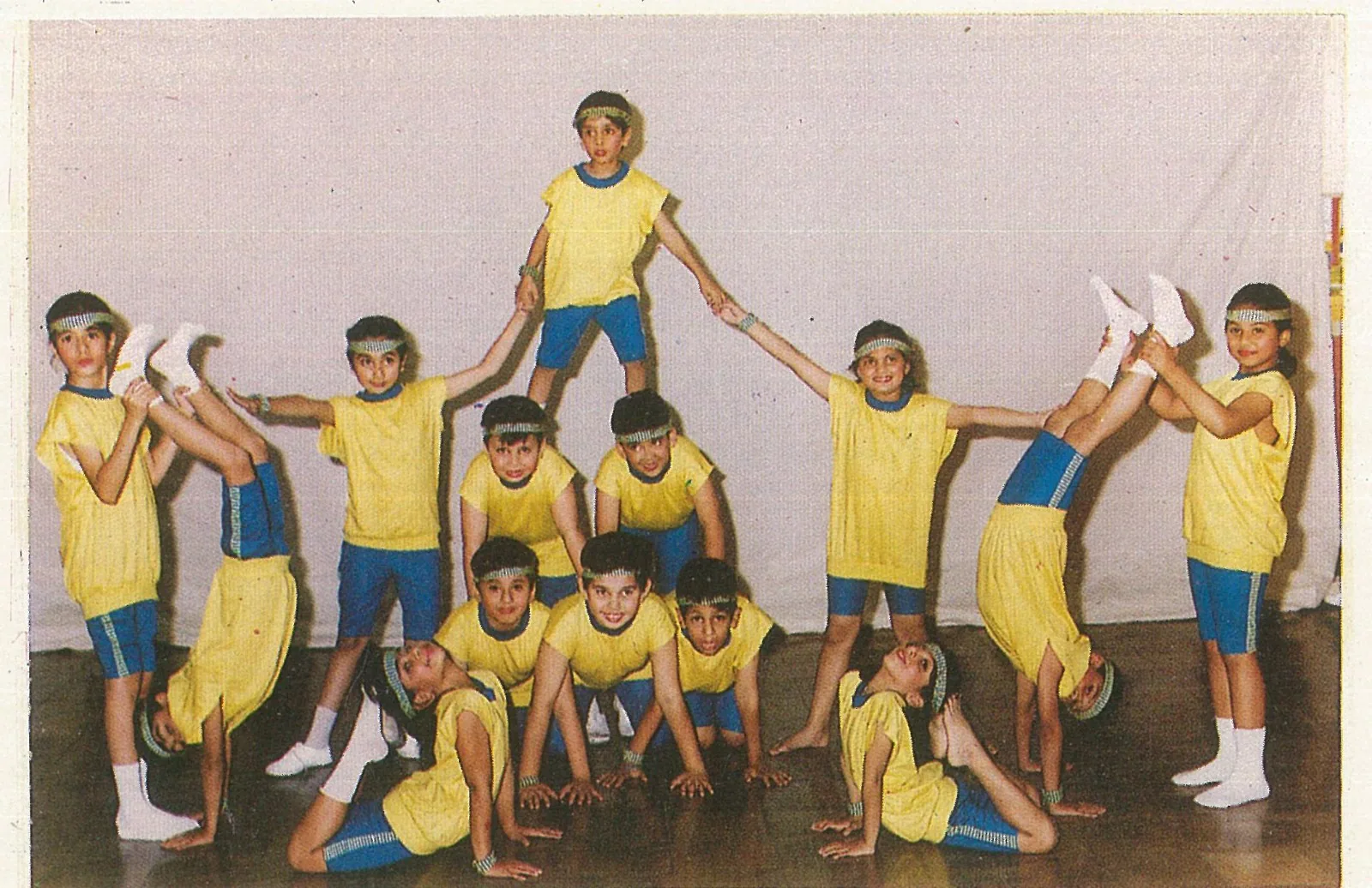 Children in yellow costumes arranged for a performance